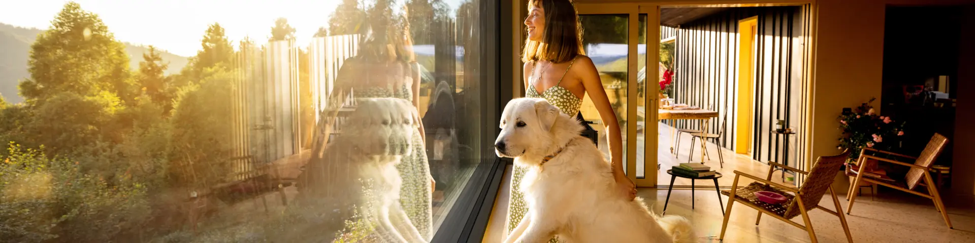 Woman with her dog in front of a large window